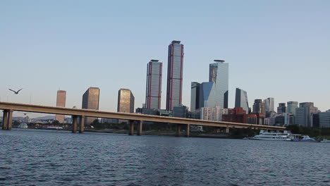 city skyline with river and bridge