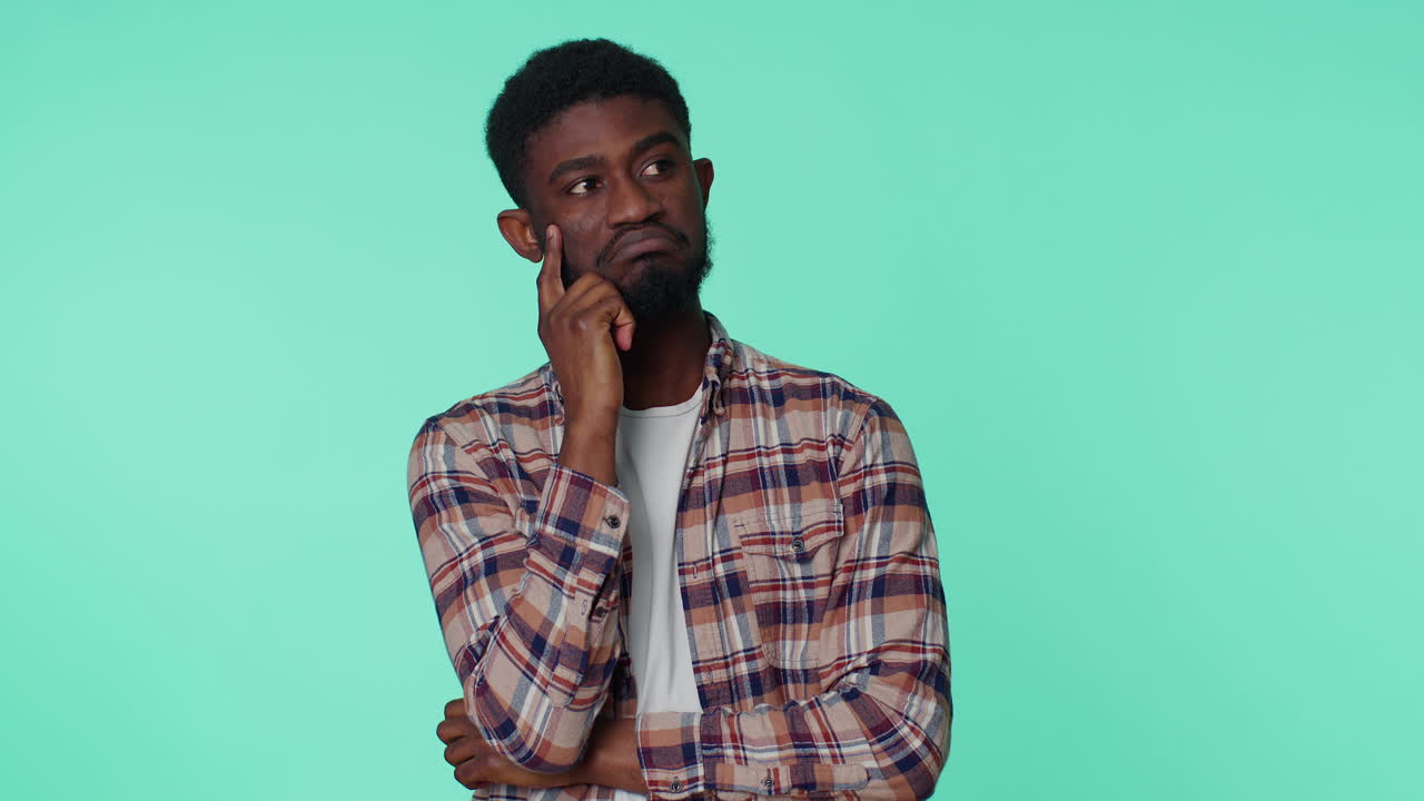 Doubting pensive man pondering and imagining in mind, wondering difficult solution feeling confused