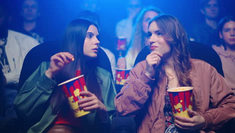 attractive girls watching film in cinema