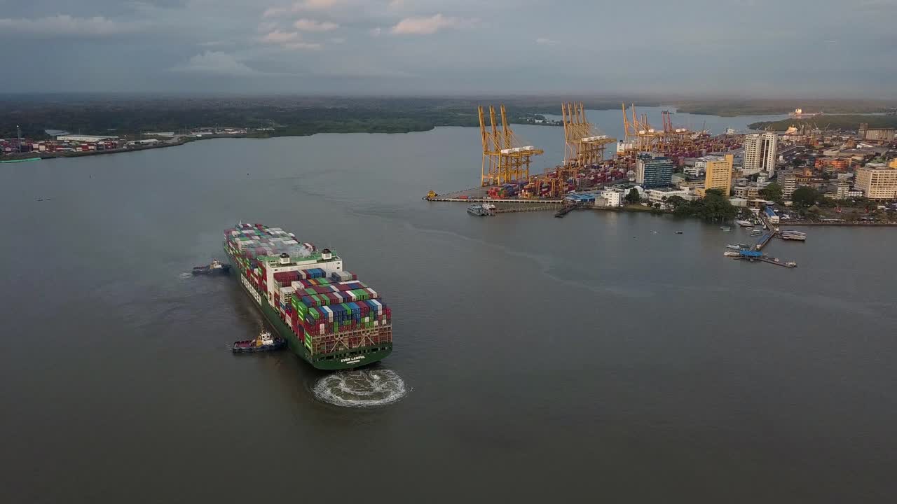 Aerial shot over big merchant ship arriving at the port in Buenaventura
