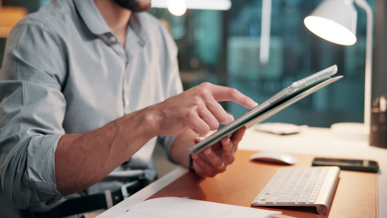 Man Using Digital Tablet at Desk in Modern Office