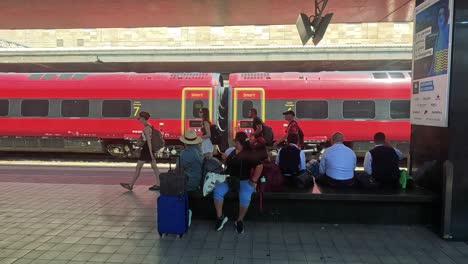 people waiting at a train station platform