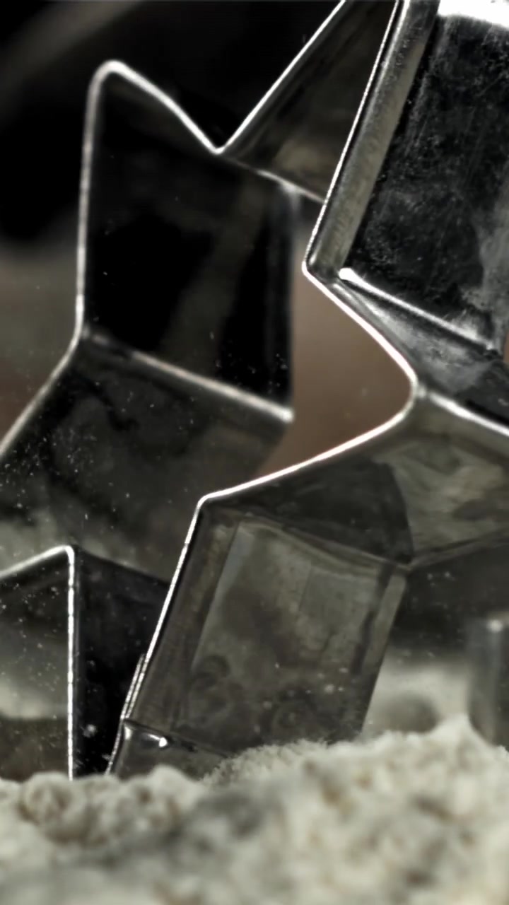 Slow Motion Close-up of a Cookie Cutter Pressing into Flour