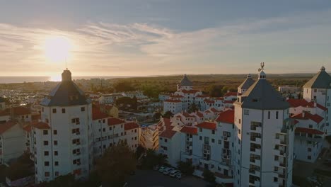 a drone footage of a european town during sunset