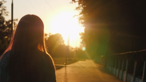 silhouette of a child walking down an alley flooded with sunlight