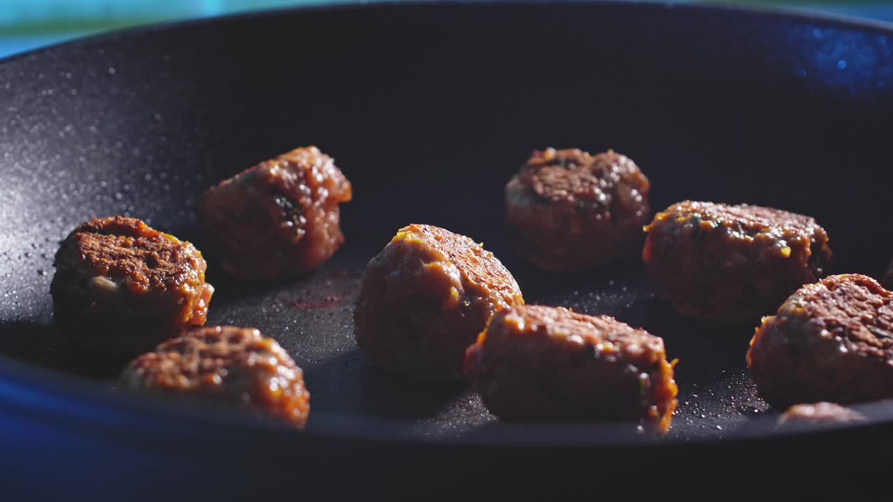Close Up Of Ground Turkey Meatballs In Non-stick Frying Pan