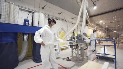 factory workers handling and processing materials on a production line