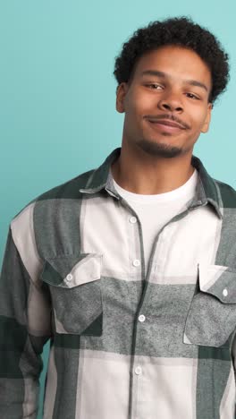 happy young man in shirt looking at camera