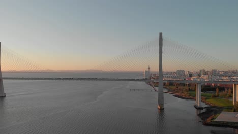 vasco da gama bridge and lisbon coast at sunrise, portugal