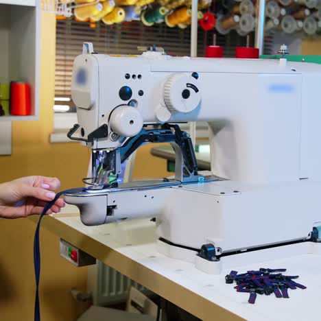 seamstresses work in main sewing shop. close up of tailor hands working at the sewing factory