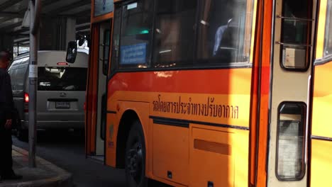 orange city bus navigating through traffic