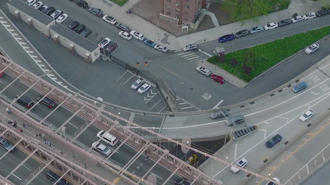 Aerial view of a city street with cars and a bridge