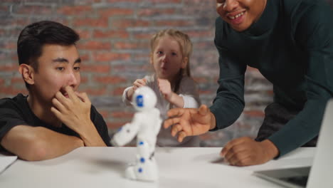 Student dances with robot under engineers control in studio