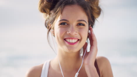 Face,-laughing-or-woman-and-earphones-by-beach