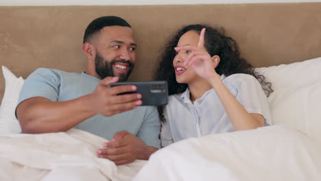 Phone,-bed-and-happy-couple-streaming-online