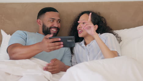 phone, bed and happy couple streaming online