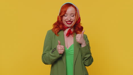 redheaded woman raises thumbs up agrees or gives positive reply recommends advertisement likes good