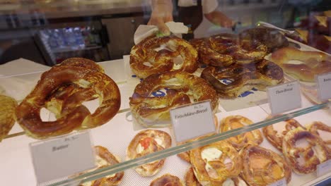 selecting a pretzel from a display case