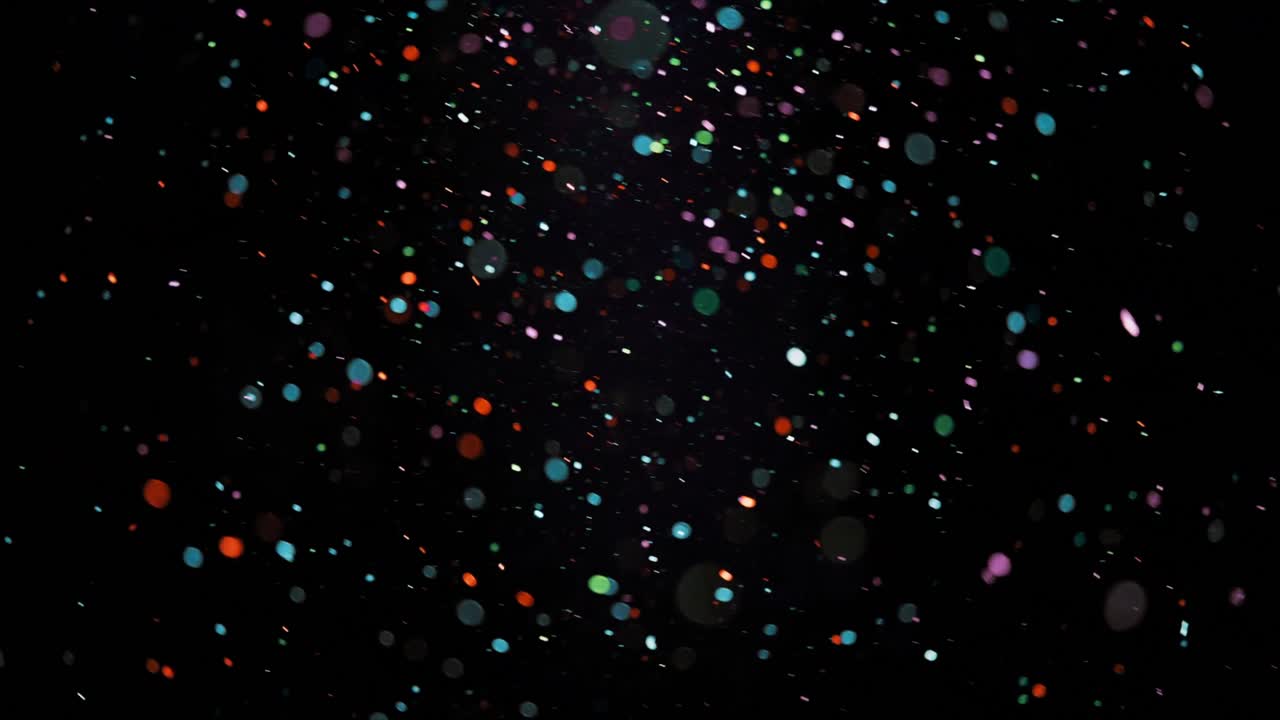 Colorful Bokeh Particles Floating on Black Background