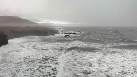 Aerial-footage-over-a-black-beach-in-Djupavogshreppur,-Iceland-9