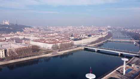 Cityscape-view-over-Rhône-river-and-historic-bridge-Pont-de-la-Guillotière,-Lyon