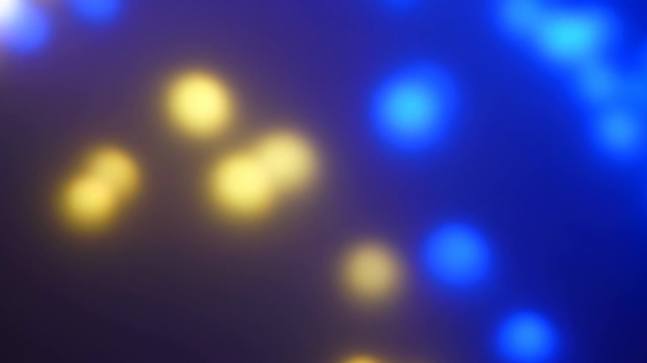 Soft Blue And Gold Bokeh Float Across Blurred Backdrop, Glowing Orbs Drift With Gentle Motion, Festival