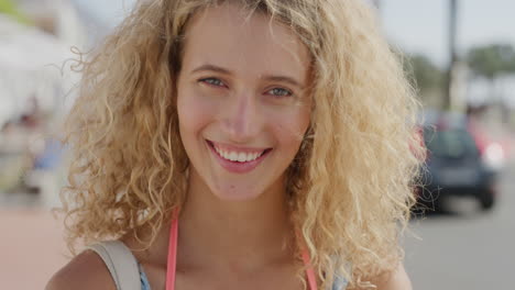 close up portrait of beautiful blonde woman smiling enjoying relaxed sunny day on summer vacation slow motion