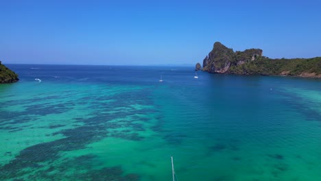 Catamaran-is-sailing-on-turquoise-water-near-a-tropical-Thai-island-on-a-sunny-day