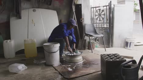 african man cleaning a wheel