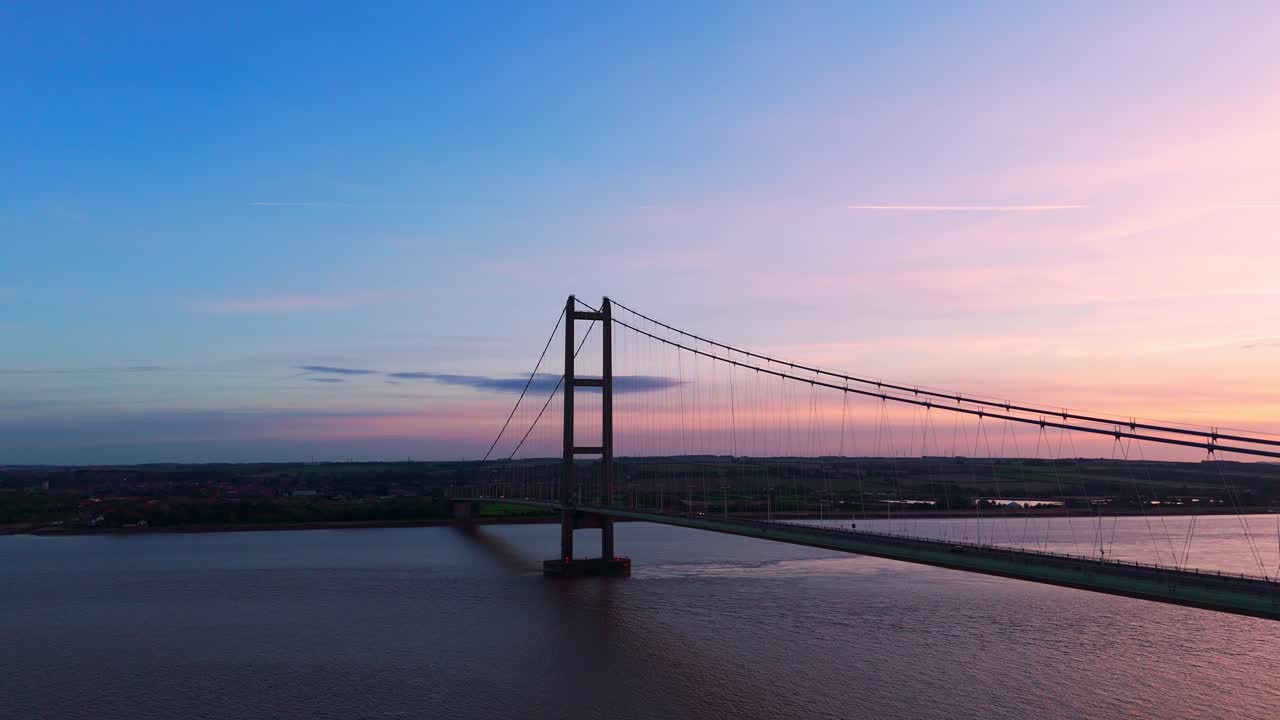 Sunset's silhouette: Humber Bridge takes center stage as cars paint a tranquil picture in an aerial drone's view