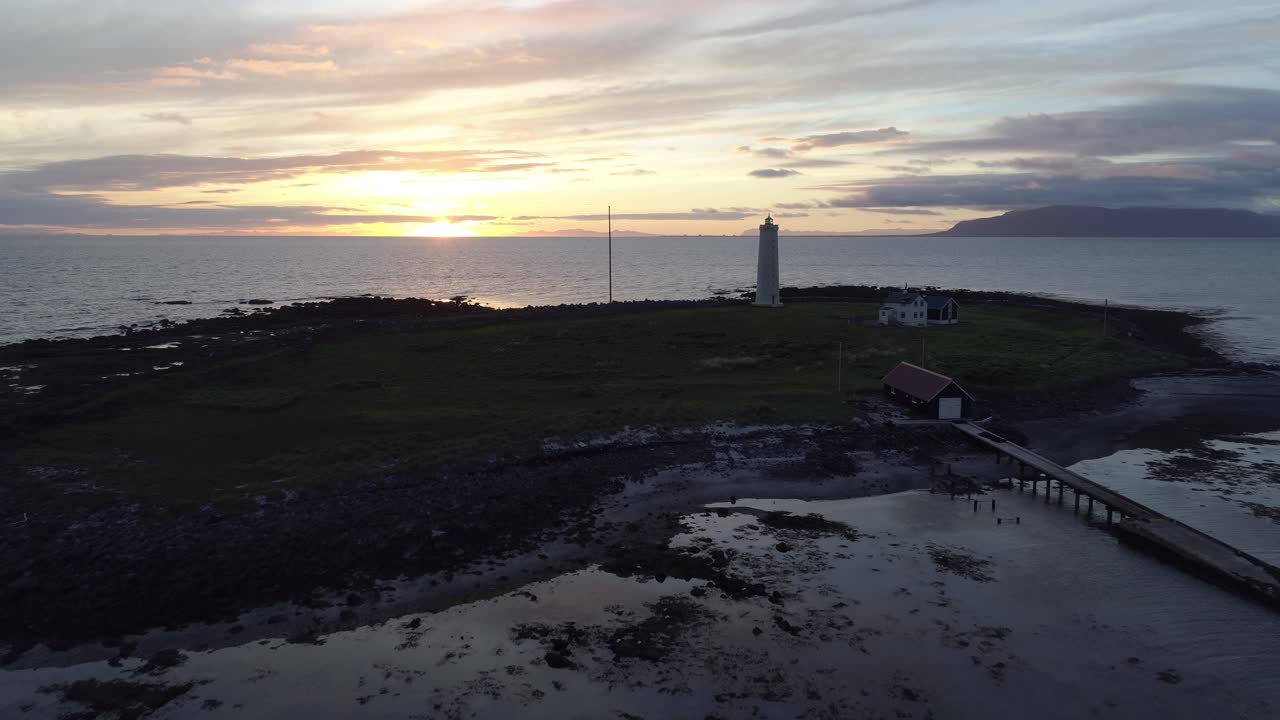 Lighthouse at Sunset on a Rocky Island
