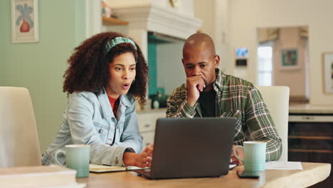 couple working on laptop at home