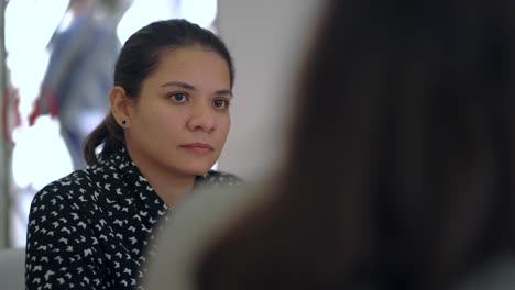 woman talking to colleague in office