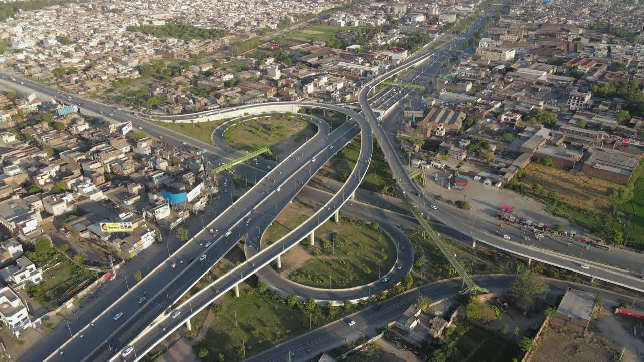4k: avión no tripulado volando sobre un paso elevado de tráfico con tráfico urbano en curso en punjab, pakistán