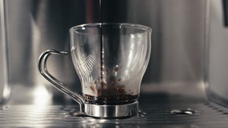 espresso machine pouring fresh double shot extraction into glass coffee cup closeup at home or cafe in slow motion 4k