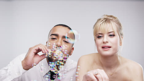 couple blowing bubbles slow motion wedding photo booth series