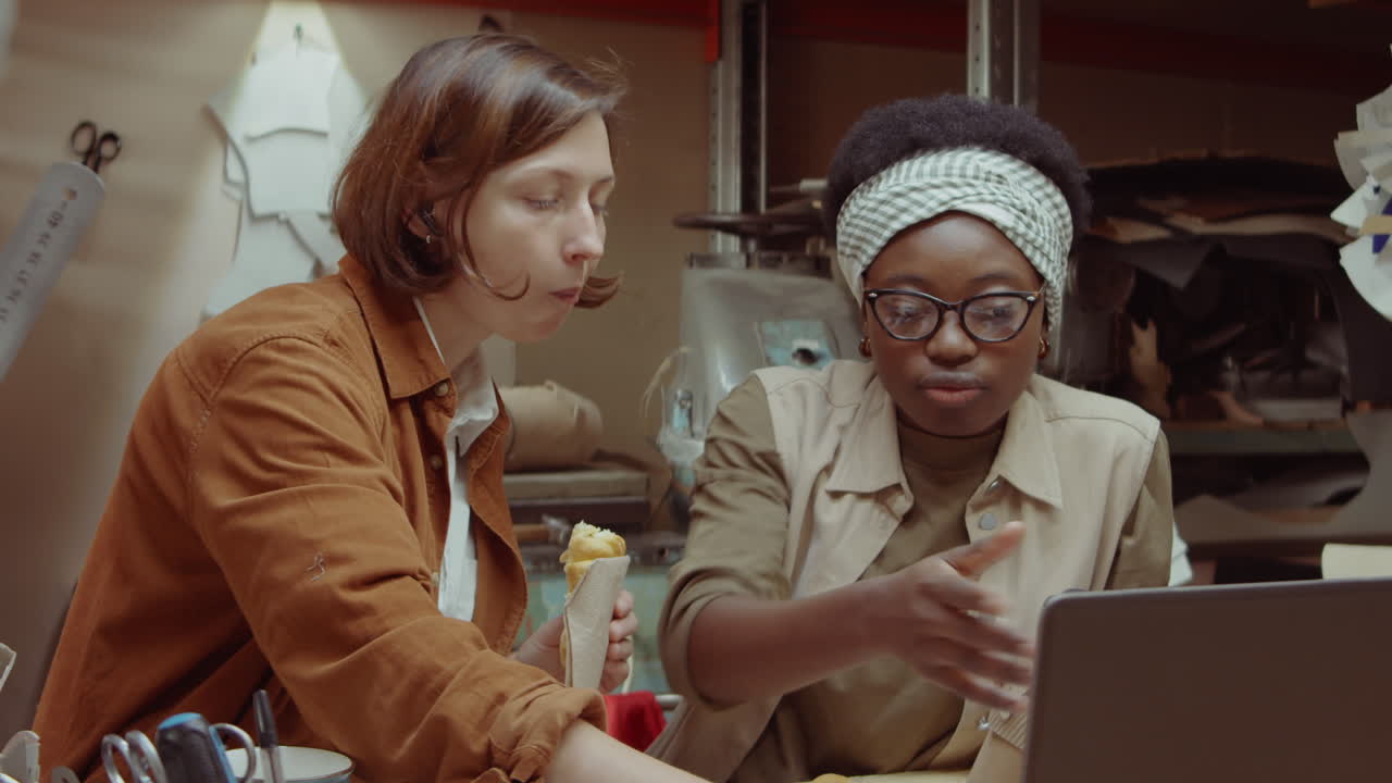 Female Shoemakers Having Coffee and Pastry in Workshop