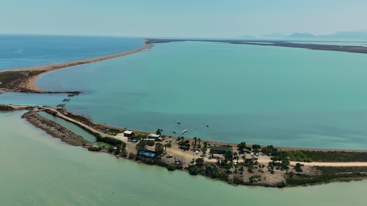 Aerial view of tranquil beach with serene blue water and distant horizon