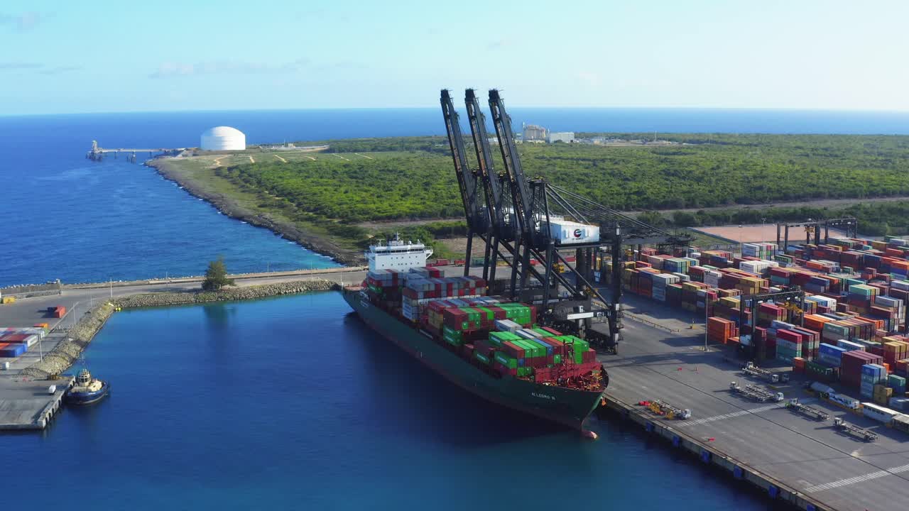 Aerial forward of cargo ship and cranes at Caucedo port, Dominican Republic