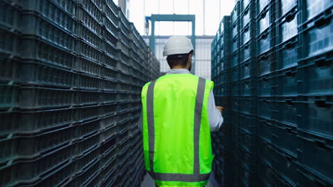 storehouse employee inspecting boxes counting distribution package in storage