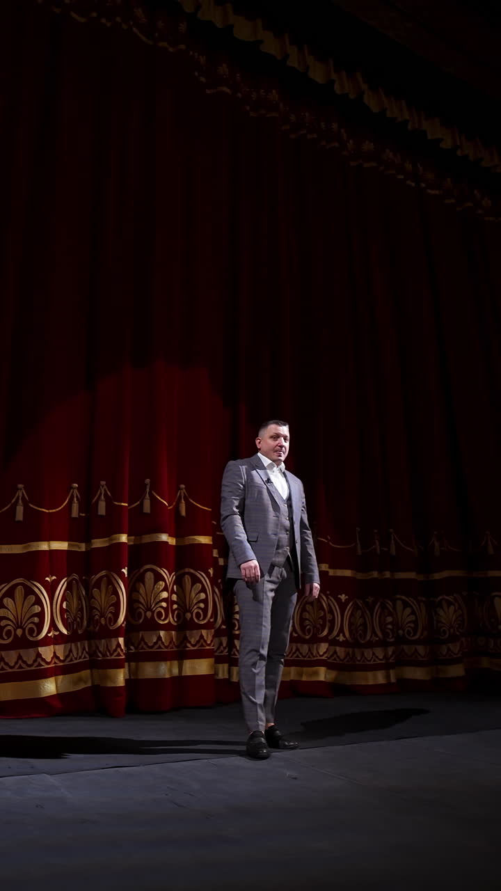 Man on stage in theater. Man speaking on stage of theatre