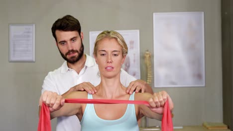 Male-physiotherapist-giving-shoulder-massage-to-female-patient