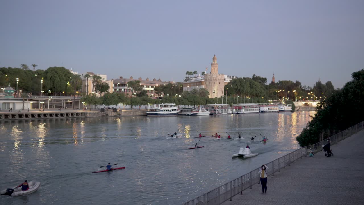 water sports canoeing in the city river, kayaking in seville in very calm blue waters. Spain and Andalusia with sports tourism