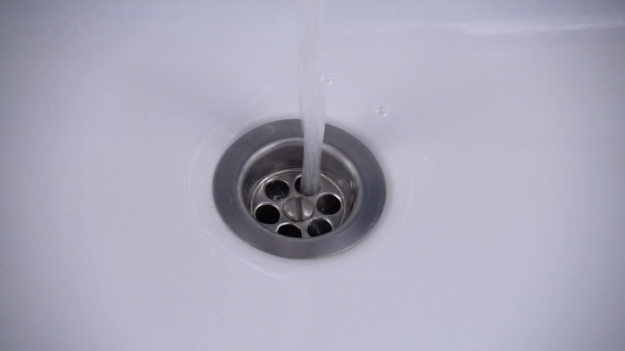 The water is washed into the water drain. Slow motion.