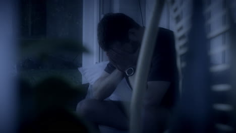 sad man crying alone late at night