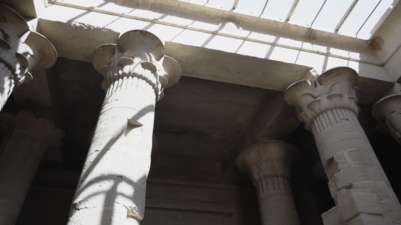 Interior of Ancient Egyptian temple dramatic shadows cast on the column