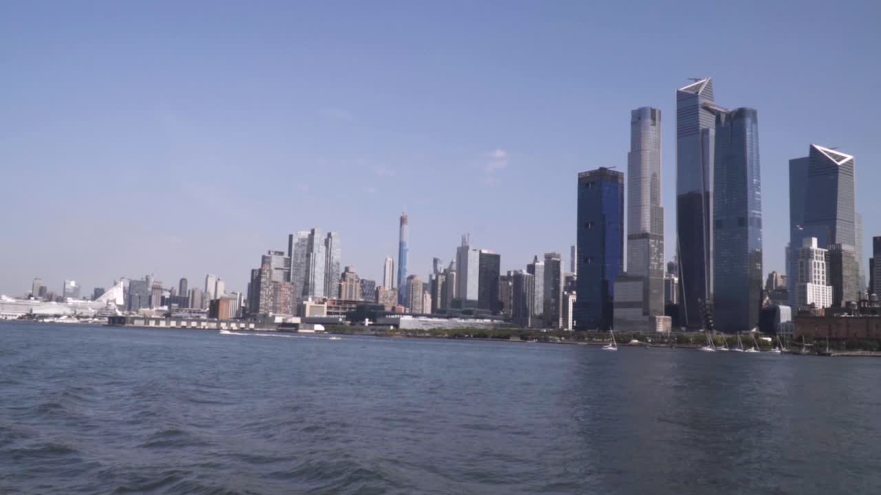 Midtown Manhattan, New York City, in slow motion from Hudson River during noon and sunny weather.