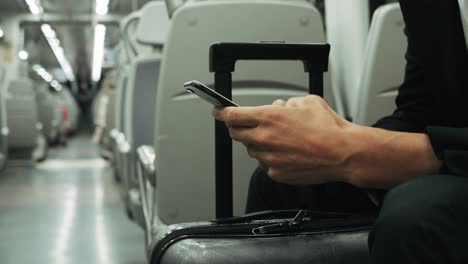 Passenger using cellphone on train