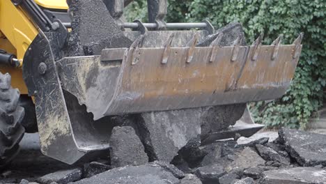 excavator removing asphalt