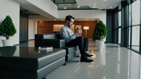 man using smartphone in office